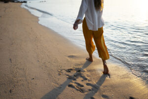 woman-walking-beach-back-view